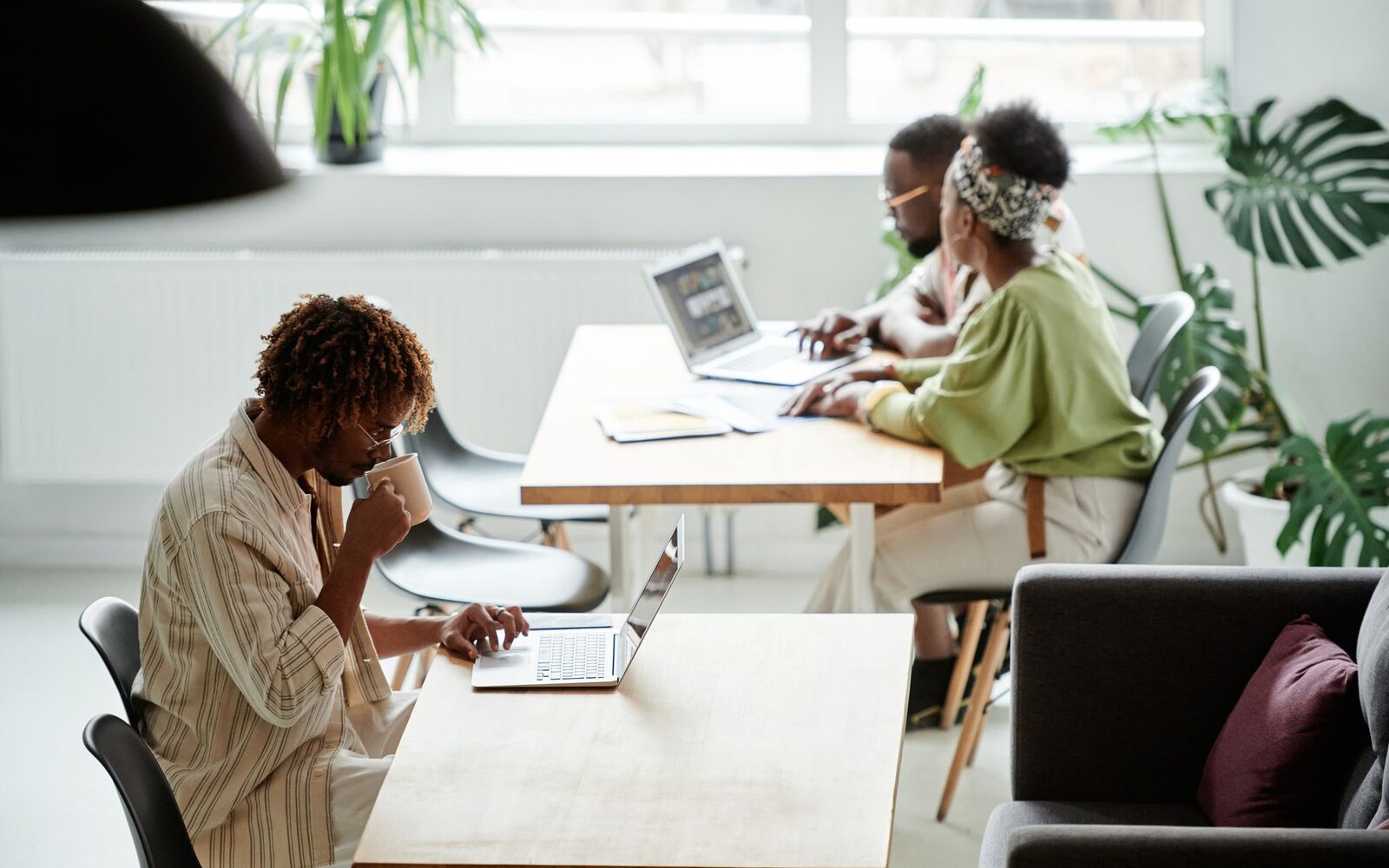 A small team working at their desks in a bright studio
